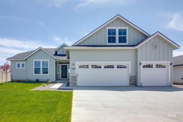 view of front of home featuring a garage, board and batten siding, concrete driveway, and a front yard