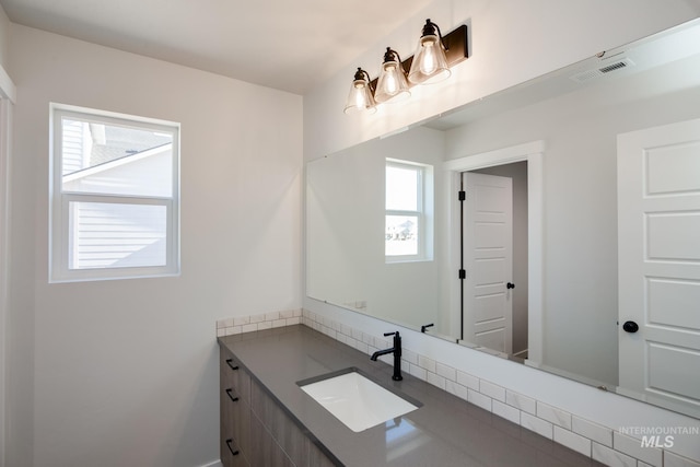 bathroom with visible vents, plenty of natural light, and vanity