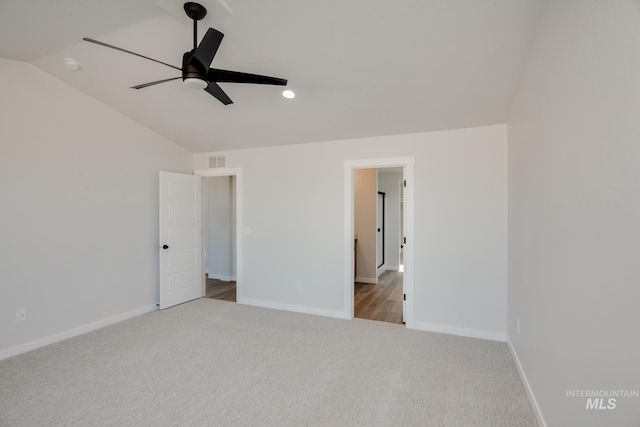 unfurnished bedroom with visible vents, baseboards, lofted ceiling, carpet flooring, and a ceiling fan