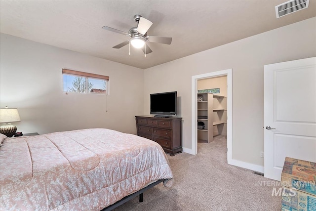 2479 N Devlin Ave, Meridian, ID 83646 - bedroom featuring carpet floors, a spacious closet, baseboards, and ceiling fan