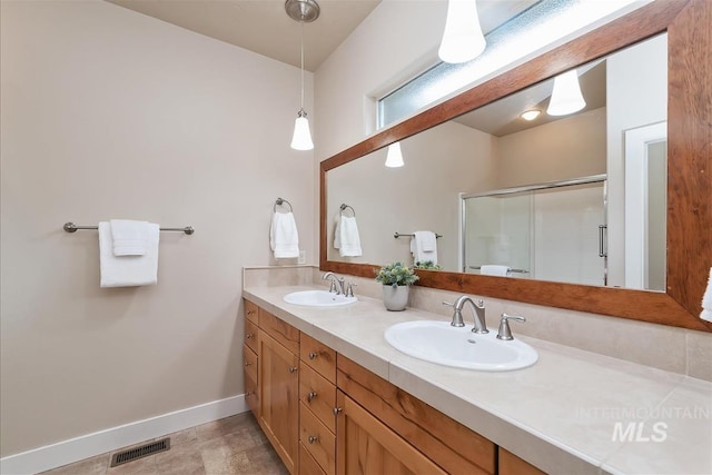 2479 N Devlin Ave, Meridian, ID 83646 - bathroom featuring baseboards, double vanity, and a stall shower
