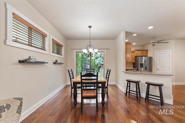 2479 N Devlin Ave, Meridian, ID 83646 - dining area featuring a chandelier, dark wood-style flooring, baseboards, recessed lighting, and a textured ceiling
