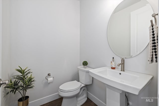 6086 S Sachet Ave, Meridian, ID 83642 - bathroom featuring baseboards, a sink, wood finished floors, and toilet
