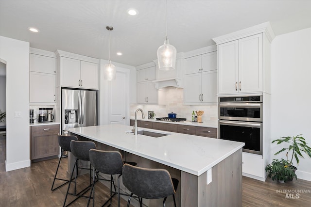 6086 S Sachet Ave, Meridian, ID 83642 - kitchen with a sink, backsplash, stainless steel appliances, and dark wood-style flooring