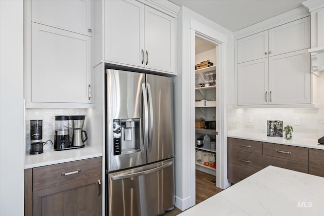 6086 S Sachet Ave, Meridian, ID 83642 - kitchen featuring stainless steel refrigerator with ice dispenser, white cabinetry, and tasteful backsplash