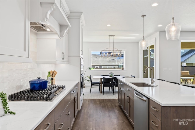 6086 S Sachet Ave, Meridian, ID 83642 - kitchen featuring a sink, stainless steel appliances, white cabinetry, and dark brown cabinets