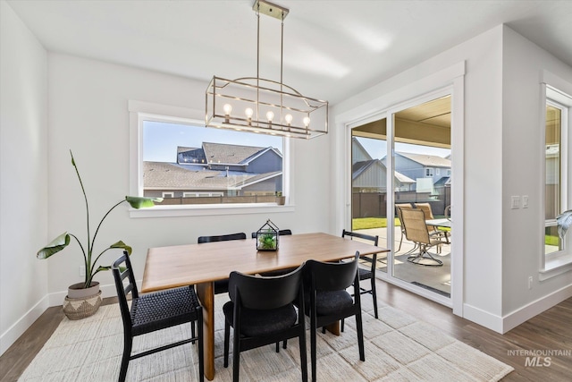 6086 S Sachet Ave, Meridian, ID 83642 - dining room featuring baseboards, a chandelier, and a healthy amount of sunlight