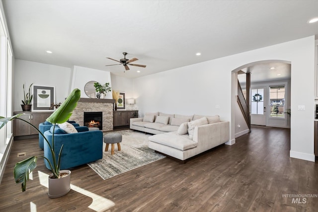 6086 S Sachet Ave, Meridian, ID 83642 - living room with a fireplace, ceiling fan, dark wood-type flooring, recessed lighting, and arched walkways