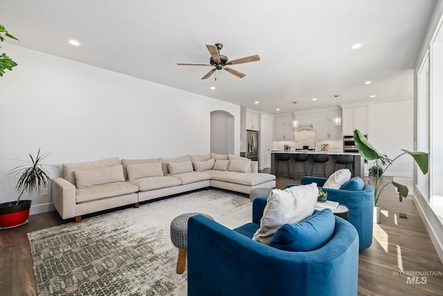 6086 S Sachet Ave, Meridian, ID 83642 - living area with baseboards, arched walkways, a ceiling fan, and wood finished floors