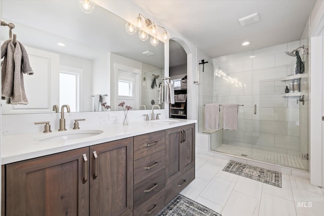 6086 S Sachet Ave, Meridian, ID 83642 - bathroom featuring a sink, a shower stall, recessed lighting, and double vanity