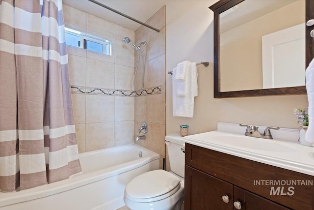 full bathroom with shower / tub combo, vanity, and toilet