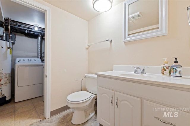 bathroom featuring gas water heater, washer / dryer, tile patterned flooring, toilet, and vanity