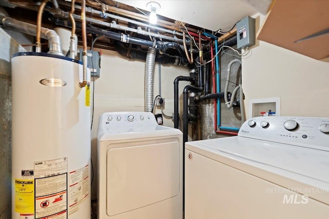 washroom with gas water heater and washing machine and dryer