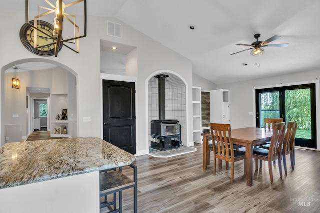 8466 W Idaho Blvd, Letha, ID 83636 - dining area featuring lofted ceiling, a wood stove, wood finished floors, healthy amount of natural light, and a ceiling fan