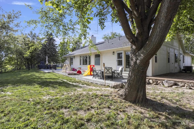 8466 W Idaho Blvd, Letha, ID 83636 - rear view of property with a patio area, central AC, a chimney, a deck, and a yard