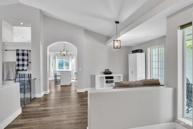8466 W Idaho Blvd, Letha, ID 83636 - living room featuring dark wood-style flooring, arched walkways, baseboards, lofted ceiling, and a chandelier