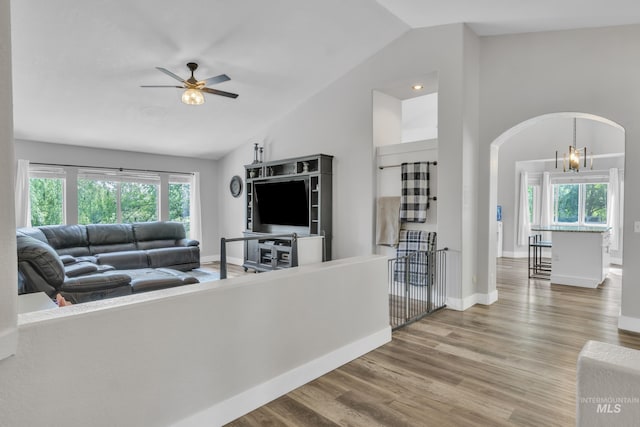 8466 W Idaho Blvd, Letha, ID 83636 - living room with vaulted ceiling, ceiling fan, arched walkways, wood finished floors, and baseboards