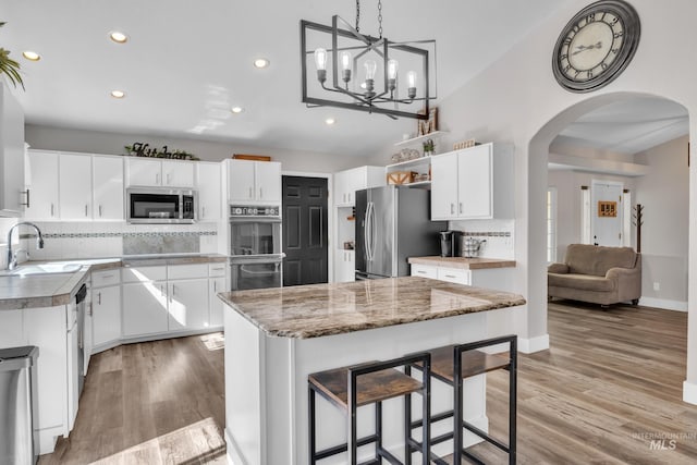 8466 W Idaho Blvd, Letha, ID 83636 - kitchen featuring stainless steel appliances, a sink, arched walkways, recessed lighting, and backsplash