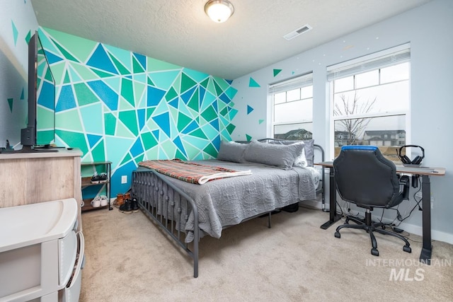 bedroom with light carpet, visible vents, and a textured ceiling