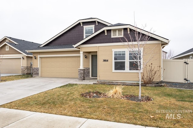 craftsman-style house with an attached garage, stone siding, a front yard, and concrete driveway
