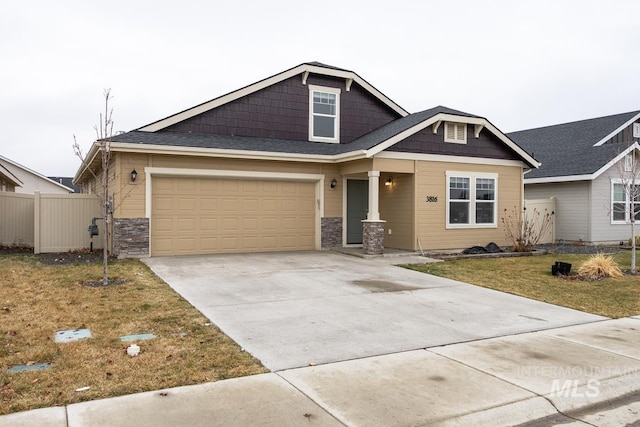 craftsman-style house featuring fence, a front lawn, concrete driveway, stone siding, and a garage