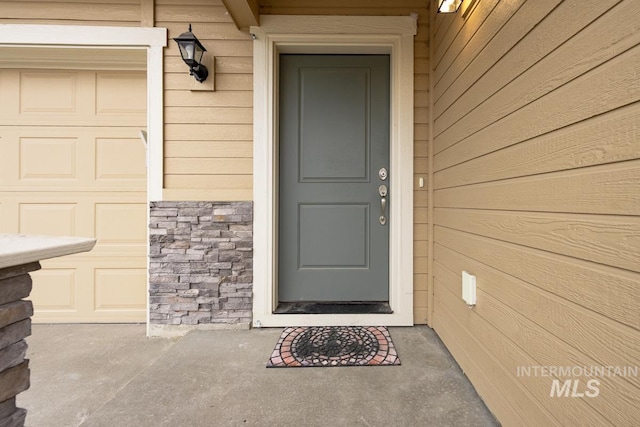 property entrance featuring stone siding