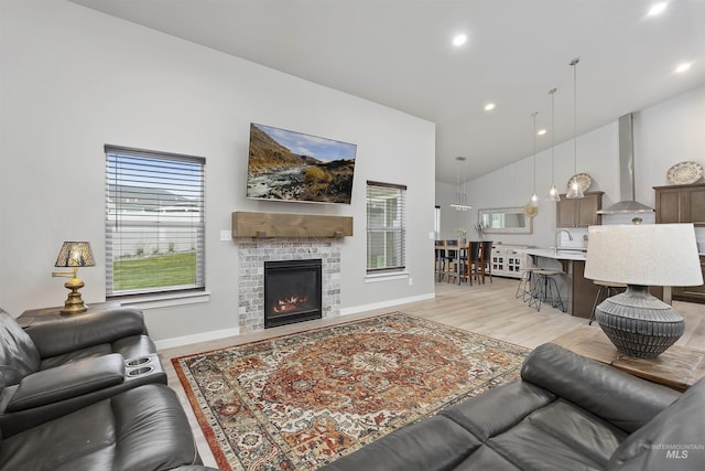 1010 Blueridge Dr, Kimberly, ID 83341 - living room featuring light wood finished floors, a glass covered fireplace, recessed lighting, and high vaulted ceiling