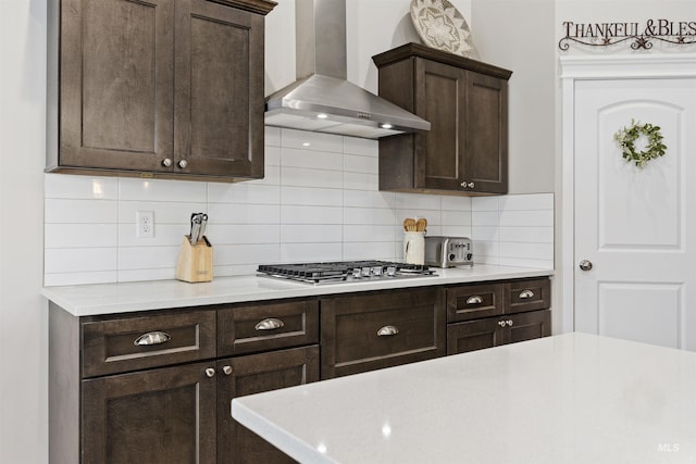 1010 Blueridge Dr, Kimberly, ID 83341 - kitchen featuring wall chimney range hood, dark brown cabinetry, light countertops, decorative backsplash, and stainless steel gas stovetop