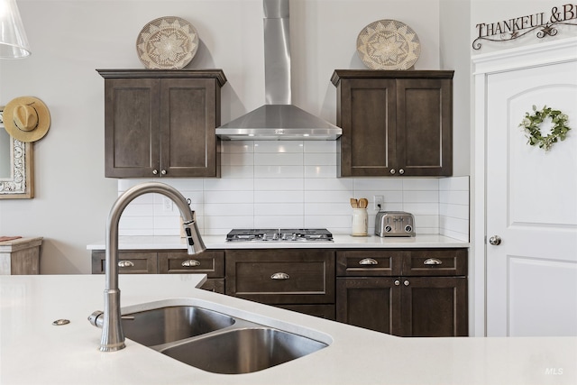 1010 Blueridge Dr, Kimberly, ID 83341 - kitchen featuring wall chimney range hood, stainless steel gas stovetop, light countertops, and dark brown cabinets