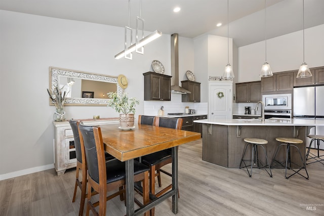 1010 Blueridge Dr, Kimberly, ID 83341 - dining room featuring light wood-style flooring, a towering ceiling, and recessed lighting