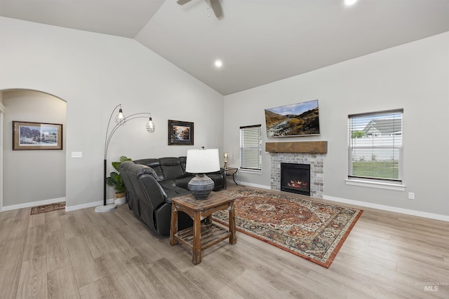1010 Blueridge Dr, Kimberly, ID 83341 - living area featuring light wood finished floors, a warm lit fireplace, a ceiling fan, arched walkways, and recessed lighting