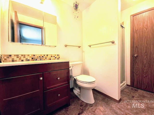 bathroom with a shower with door, toilet, and vanity