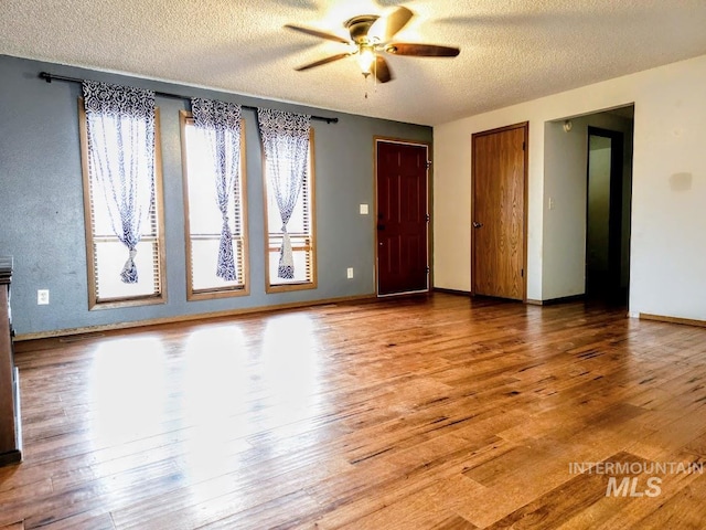 spare room featuring ceiling fan, a textured ceiling, and hardwood / wood-style flooring