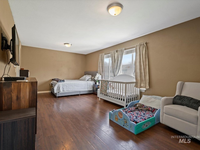 bedroom featuring baseboards and wood finished floors