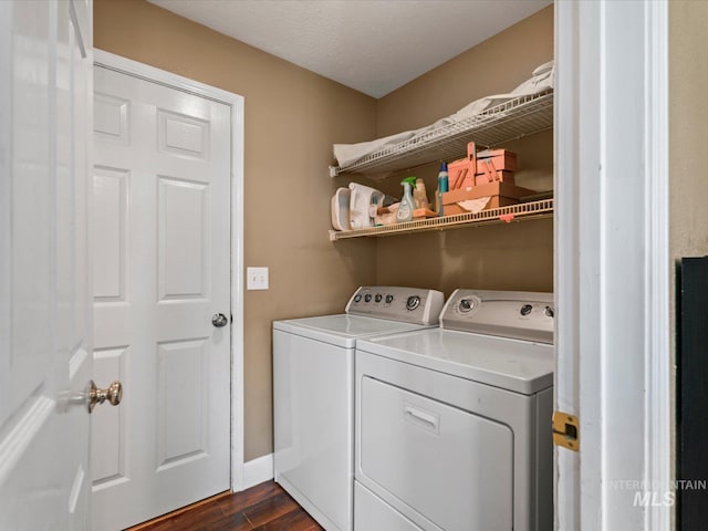 laundry area with washer and clothes dryer, laundry area, and dark wood finished floors