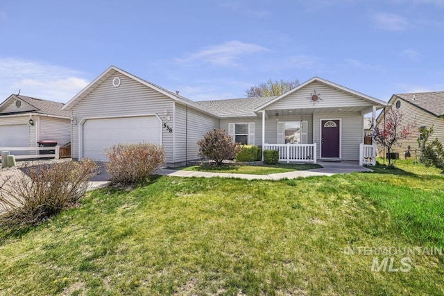 ranch-style home featuring an attached garage, a front yard, and covered porch
