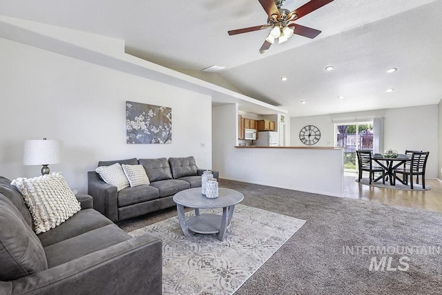 carpeted living area with ceiling fan, lofted ceiling, baseboards, and recessed lighting