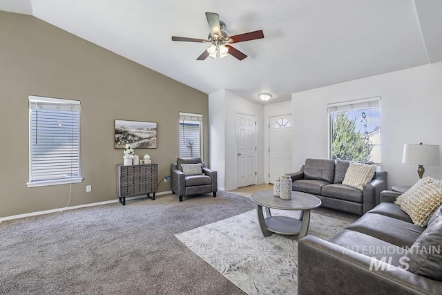 carpeted living area with high vaulted ceiling, a wealth of natural light, a ceiling fan, and baseboards