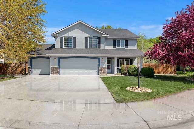 7362 S Shadowmoss Ave, Boise, ID 83709 - traditional-style home featuring driveway, covered porch, stone siding, a garage, and a shingled roof