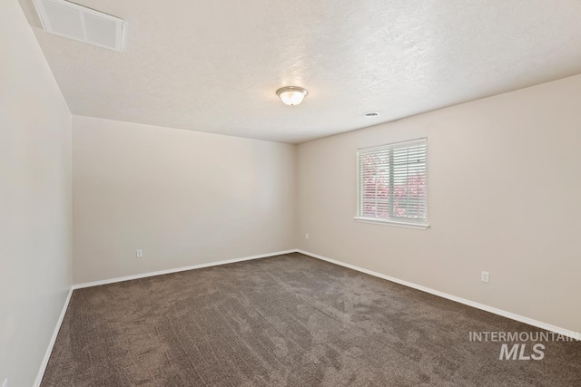 7362 S Shadowmoss Ave, Boise, ID 83709 - unfurnished room featuring dark carpet, baseboards, and a textured ceiling
