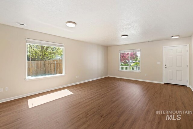 7362 S Shadowmoss Ave, Boise, ID 83709 - empty room featuring wood finished floors and baseboards