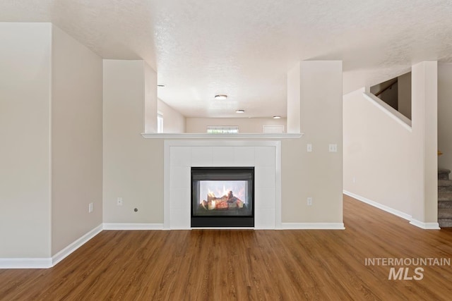 7362 S Shadowmoss Ave, Boise, ID 83709 - unfurnished living room with wood finished floors, baseboards, and stairway