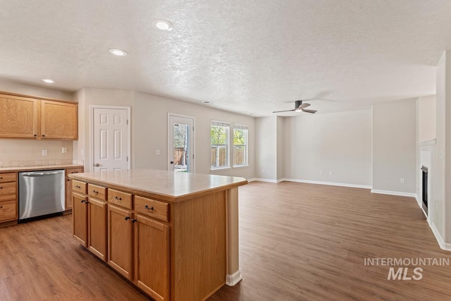 7362 S Shadowmoss Ave, Boise, ID 83709 - kitchen with dishwasher, a textured ceiling, wood finished floors, a ceiling fan, and light countertops