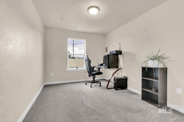 carpeted office space with baseboards