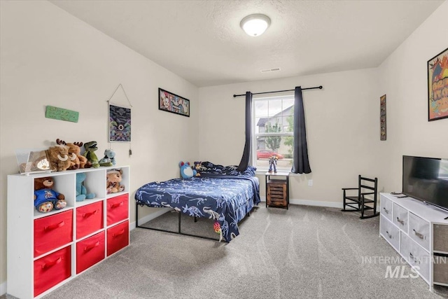 bedroom with carpet floors and baseboards