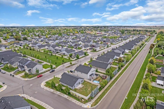 aerial view of property and surrounding area with nearby suburban area