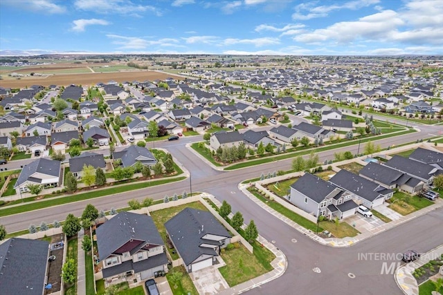 aerial view of property and surrounding area featuring nearby suburban area
