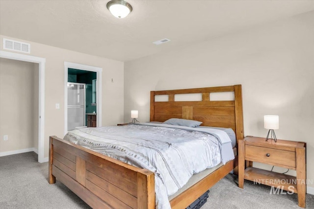 carpeted bedroom with baseboards and connected bathroom