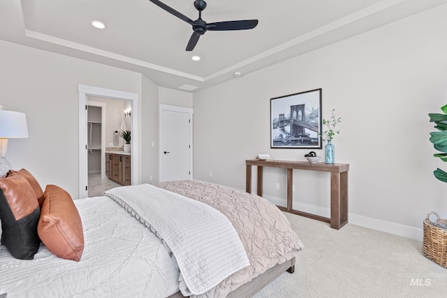 1501 E Andes Dr, Kuna, ID 83634 - bedroom with a tray ceiling, recessed lighting, light colored carpet, ceiling fan, and connected bathroom