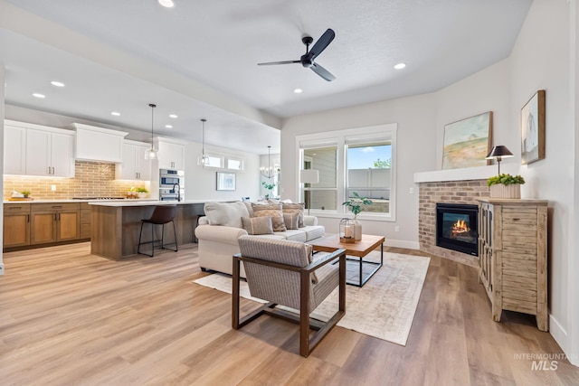 1501 E Andes Dr, Kuna, ID 83634 - living room with plenty of natural light, a fireplace, light wood-style floors, ceiling fan, and recessed lighting